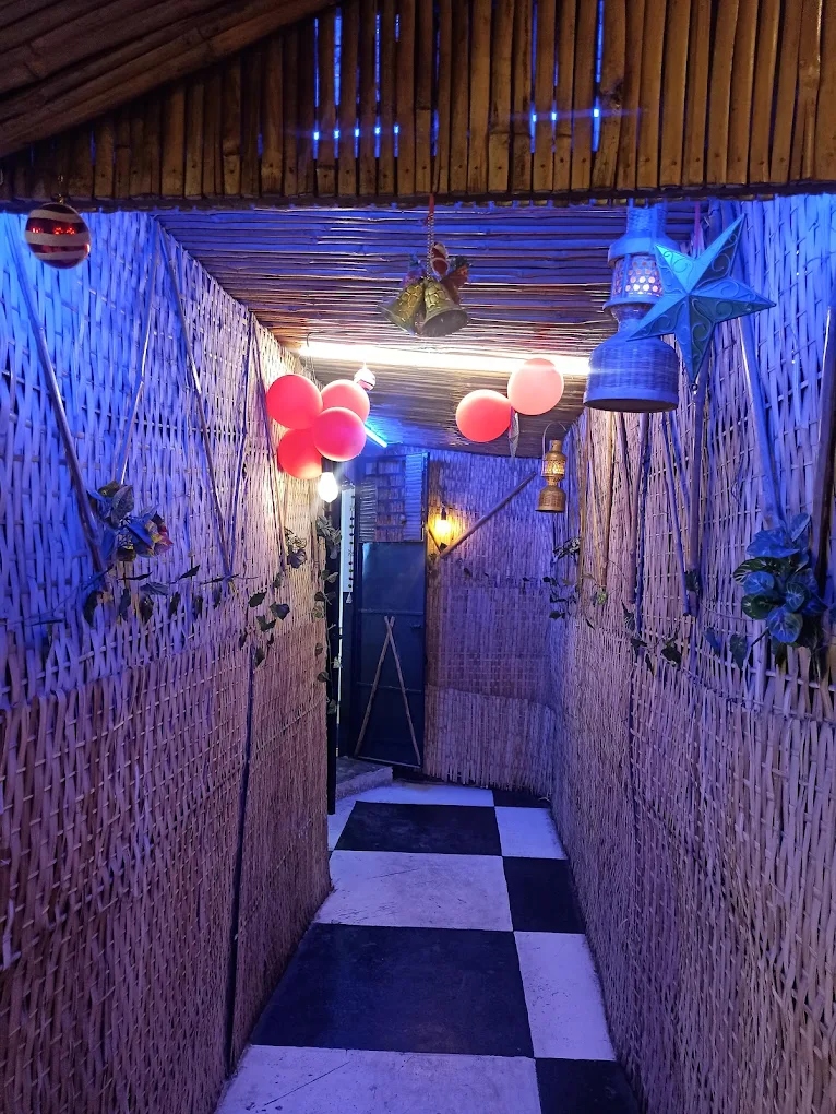 LSD entrance corridor with bamboo walls, blue lighting, red balloons and checkered floor